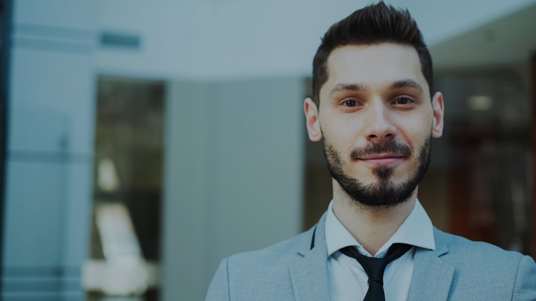 Young businessman in a suit smiling confidently