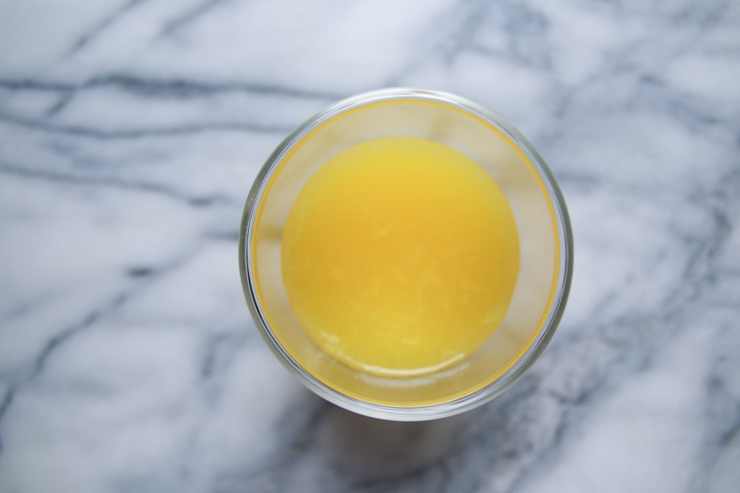 A glass of orange juice on a marble table