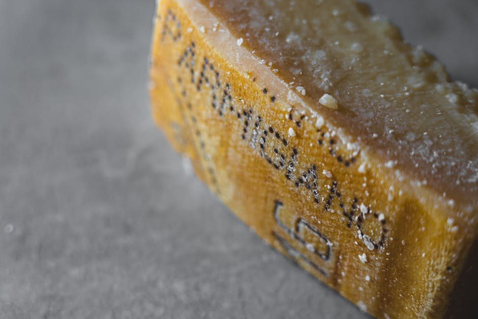Detailed shot of Parmigiano Reggiano cheese showcasing its textured and aged surface.