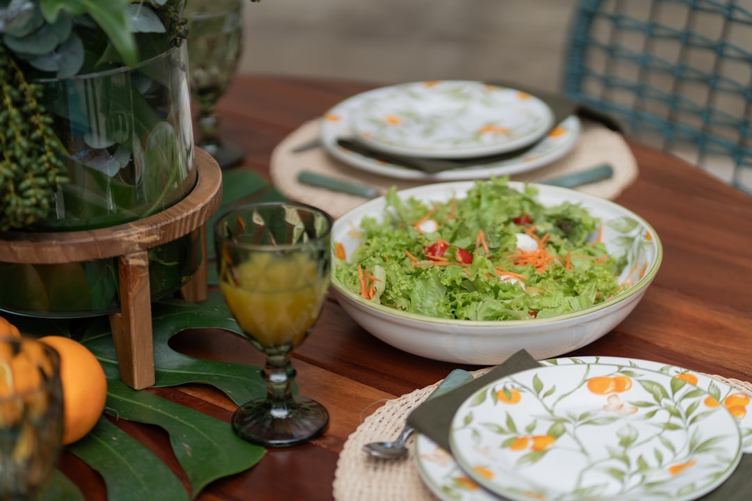 a wooden table topped with plates and bowls of food