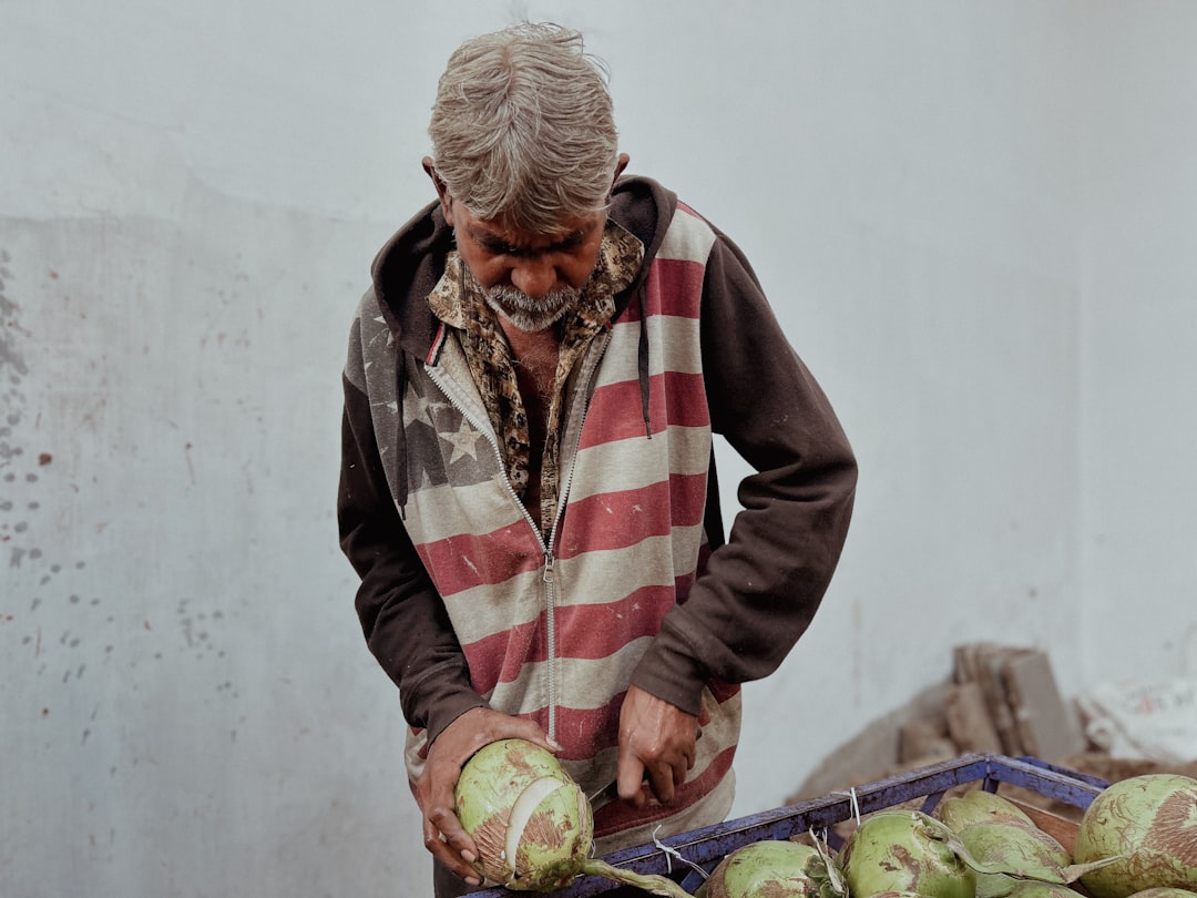 A man standing over a pile of fruit
