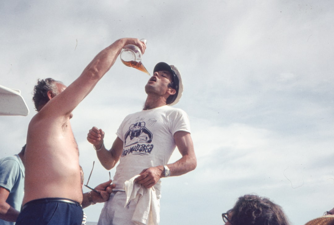 a man in a white shirt is reaching for a frisbee
