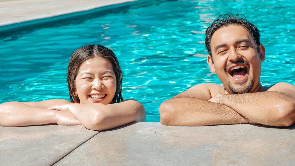 Two friends enjoying a sunny day by a pool, smiling and having fun.