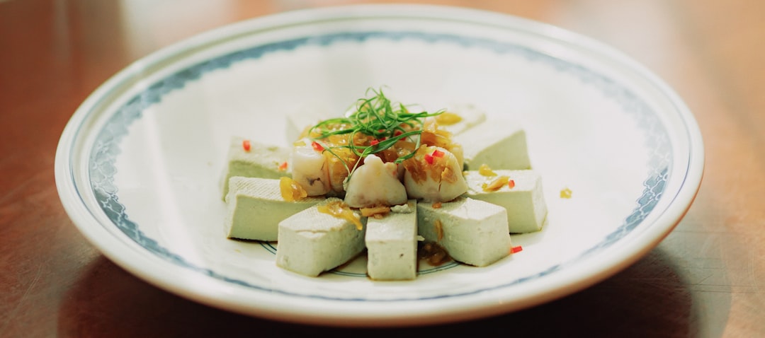 white and green food on white and blue ceramic plate