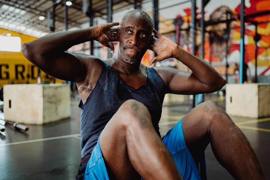 Focused man performs sit-up exercises indoors, showcasing fitness and determination.