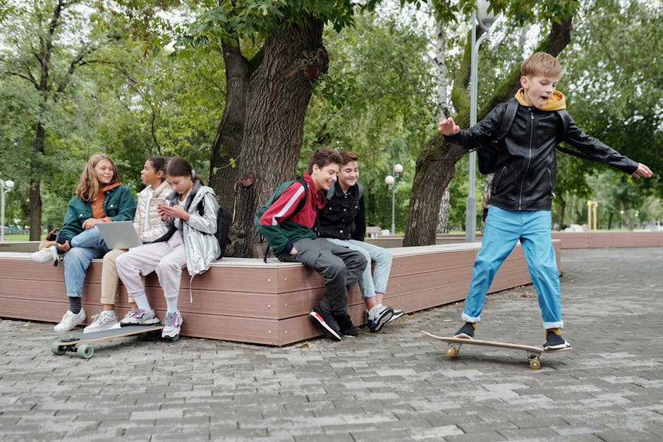 Group of teenagers having fun with skateboarding in an outdoor park setting.