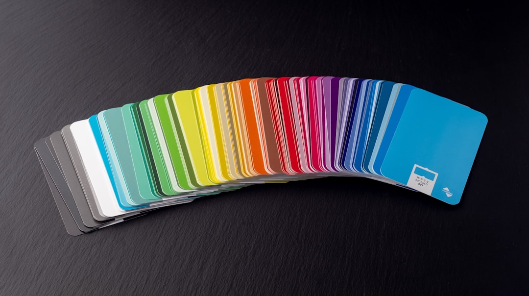 a stack of rainbow colored cards sitting on top of a table