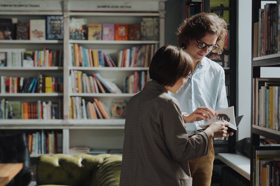 Two individuals engage in a lively book discussion in a cozy library setting.
