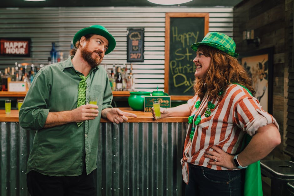 People celebrating St. Patrick's Day with drinks at a festive bar.