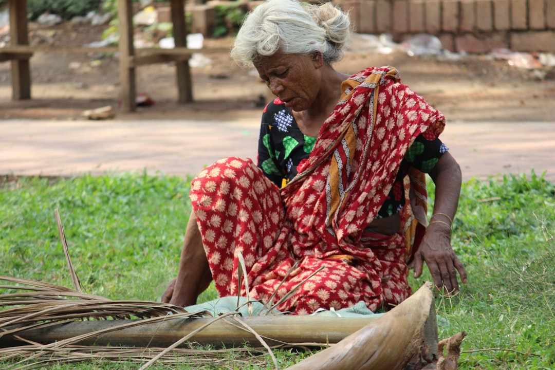 woman in black and red dress sitting on grass