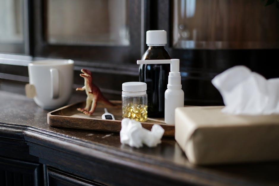 Indoor scene featuring medicines, a tea cup, tissues, and a toy dinosaur for a cozy treatment ambiance.