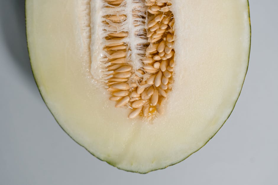 Detailed image of a honeydew melon half showcasing seeds and fresh texture.