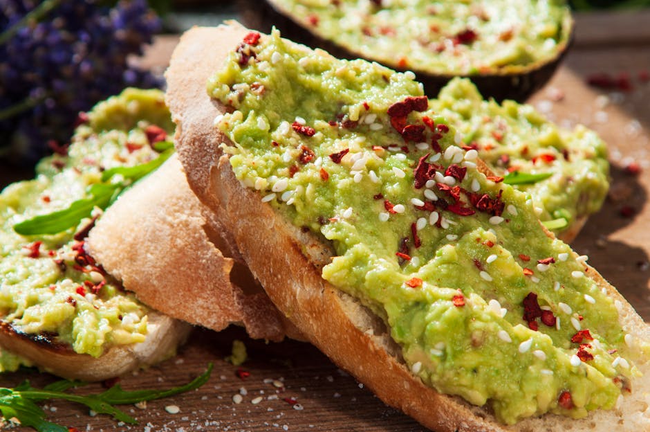 Close-up of avocado toast topped with sesame seeds and chili flakes, perfect for a fresh meal.