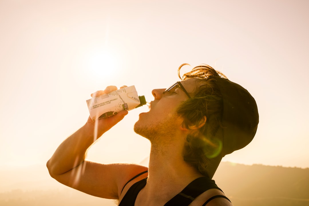a man drinking from a bottle of water