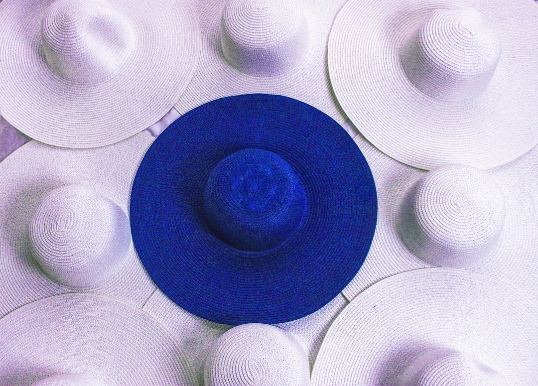 a blue and white hat surrounded by white hats