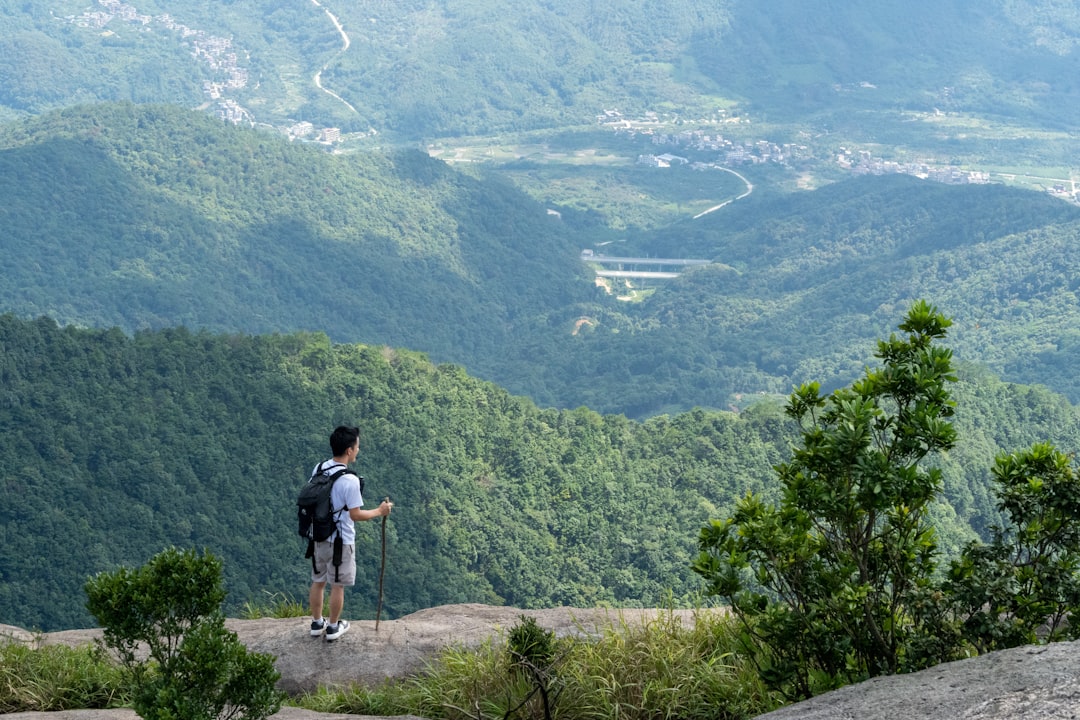 a man standing on top of a mountain with a backpack