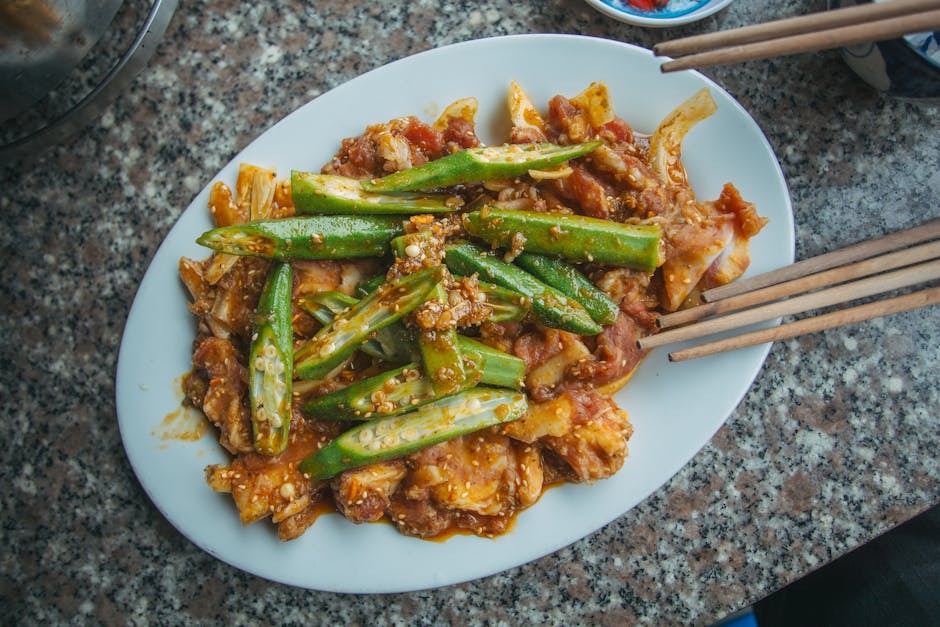 A mouthwatering dish of okra and marinated meat served on a ceramic plate, perfect for food photography.