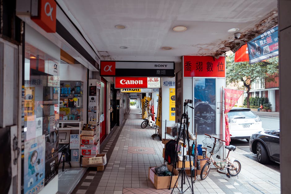 View of camera stores and bustling streetscape in Taipei showcasing various brands.