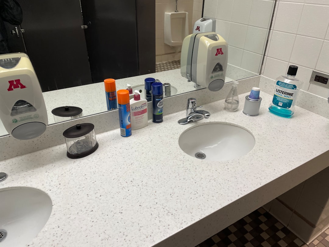A bathroom counter with a lot of personal care items on it
