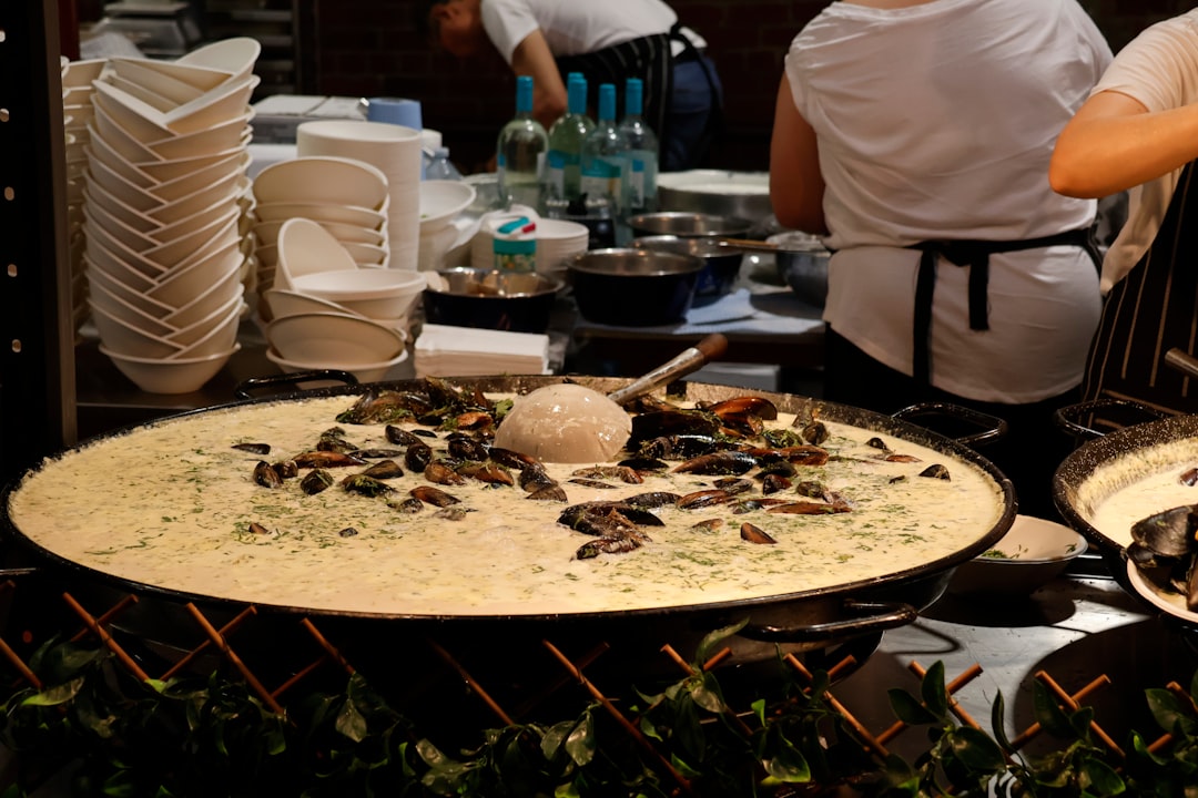 Large pan of food with mussels and rice