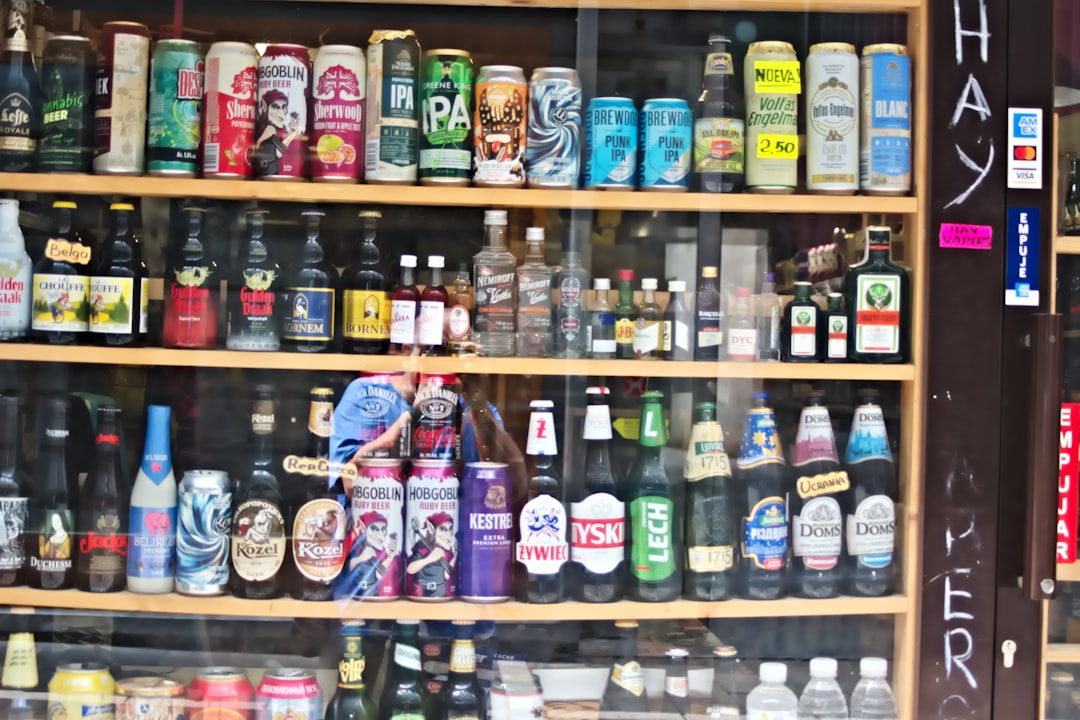 Shelves filled with assorted bottles and cans of drinks.