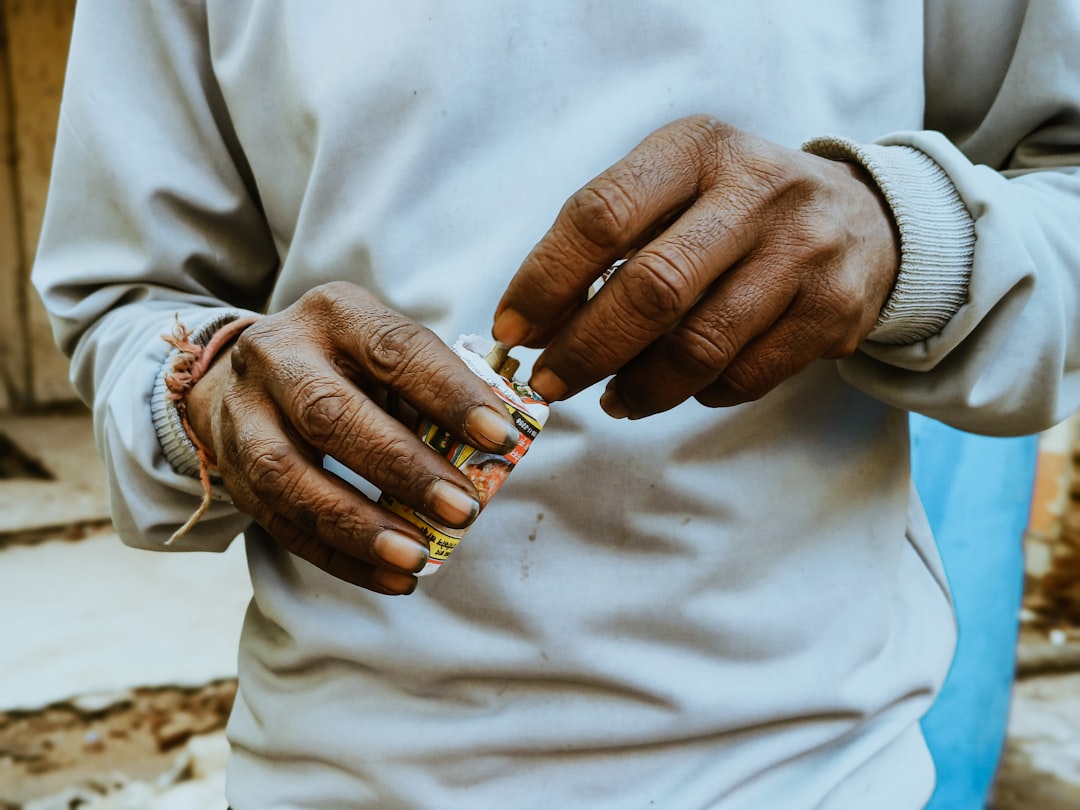 A man holding a cigarette in his hands
